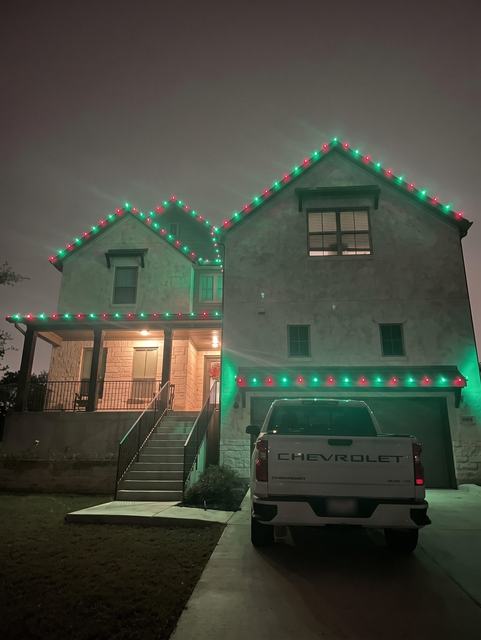Green and red roofline on two story home
